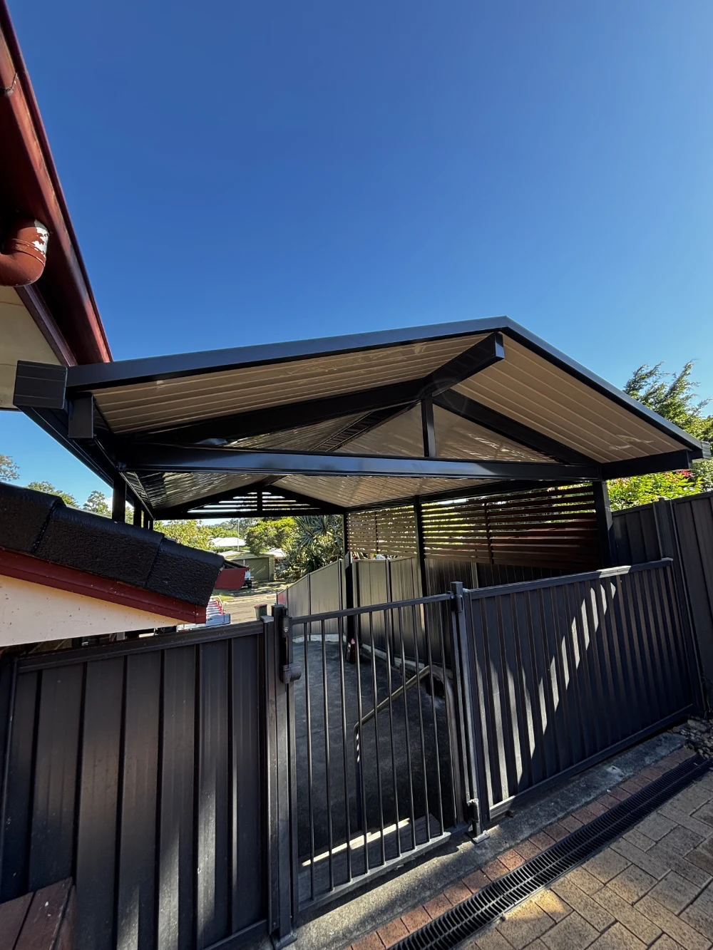 Insulated patio roof in a dark charcoal finish with an off white ceiling